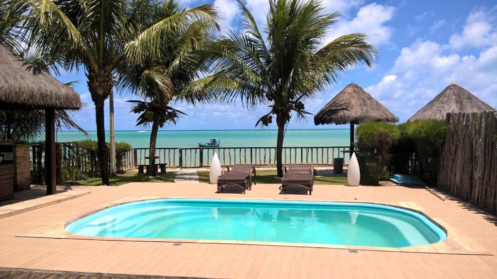 a swimming pool with a view of the beach at Villa Imperador in João Pessoa