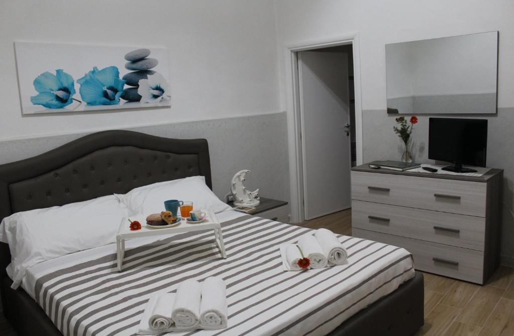 a bedroom with a bed with a tray of food on it at Casa Vacanze: Le Tre Stelle in Nardò
