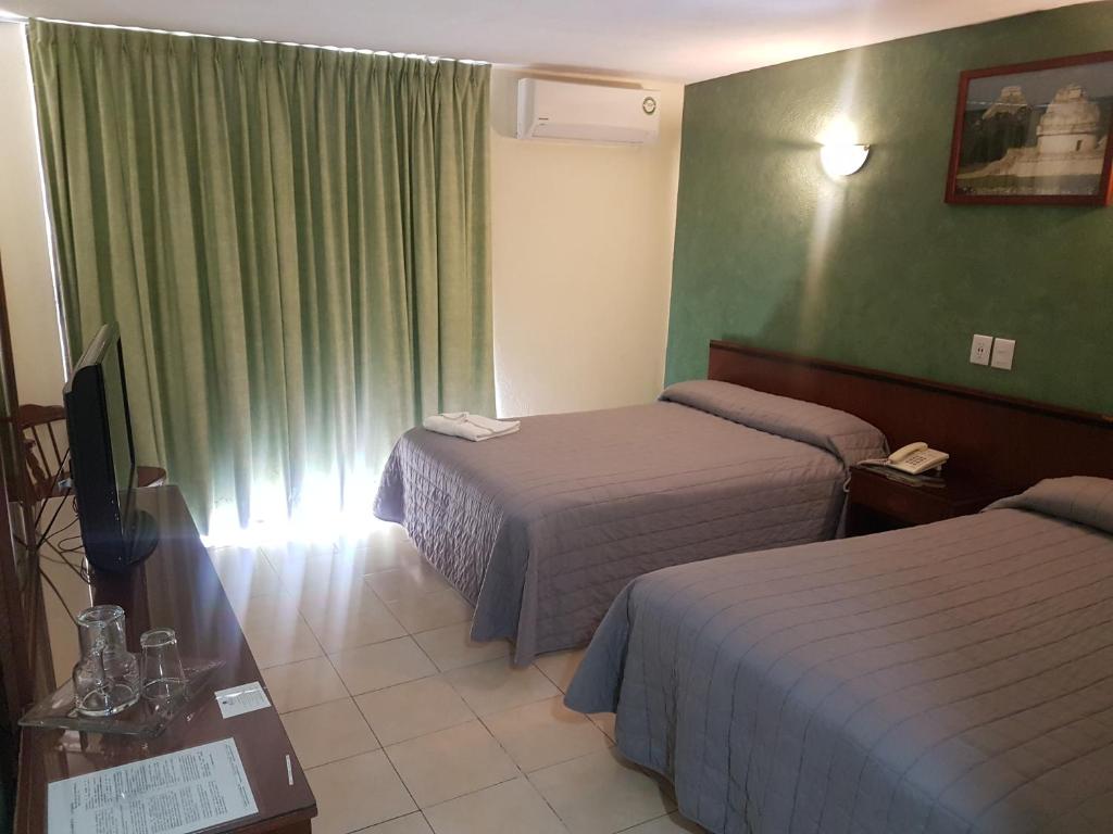 En eller flere senge i et værelse på Hotel Bello Cordoba