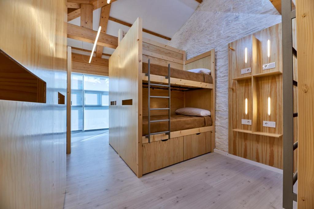 a large room with bunk beds in it at Albergue San Francisco in Arzúa