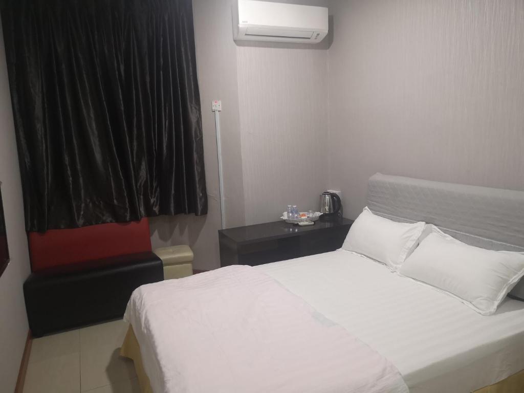 Postel nebo postele na pokoji v ubytování Home Inn Hotel