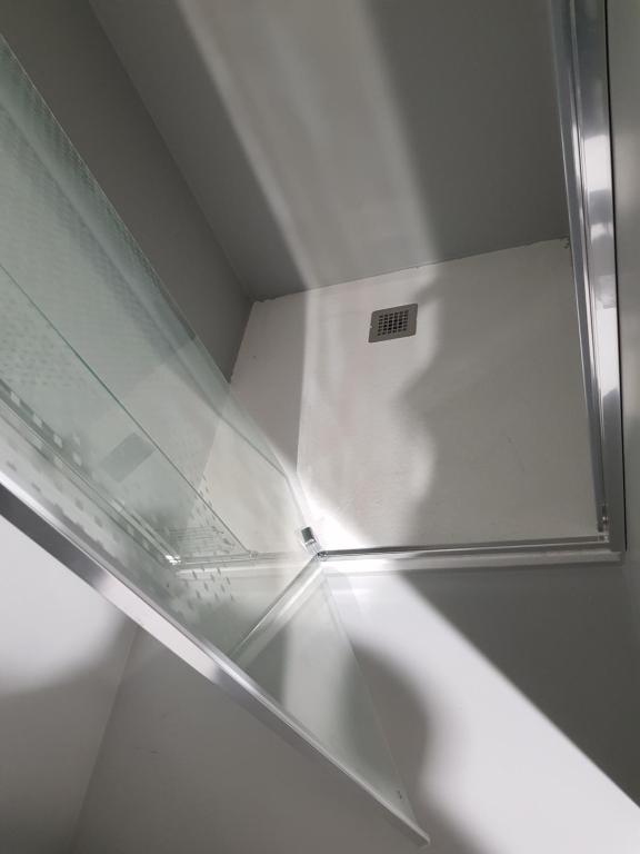 a glass shelf in a refrigerator in a room at B&B The Project in Heerlen