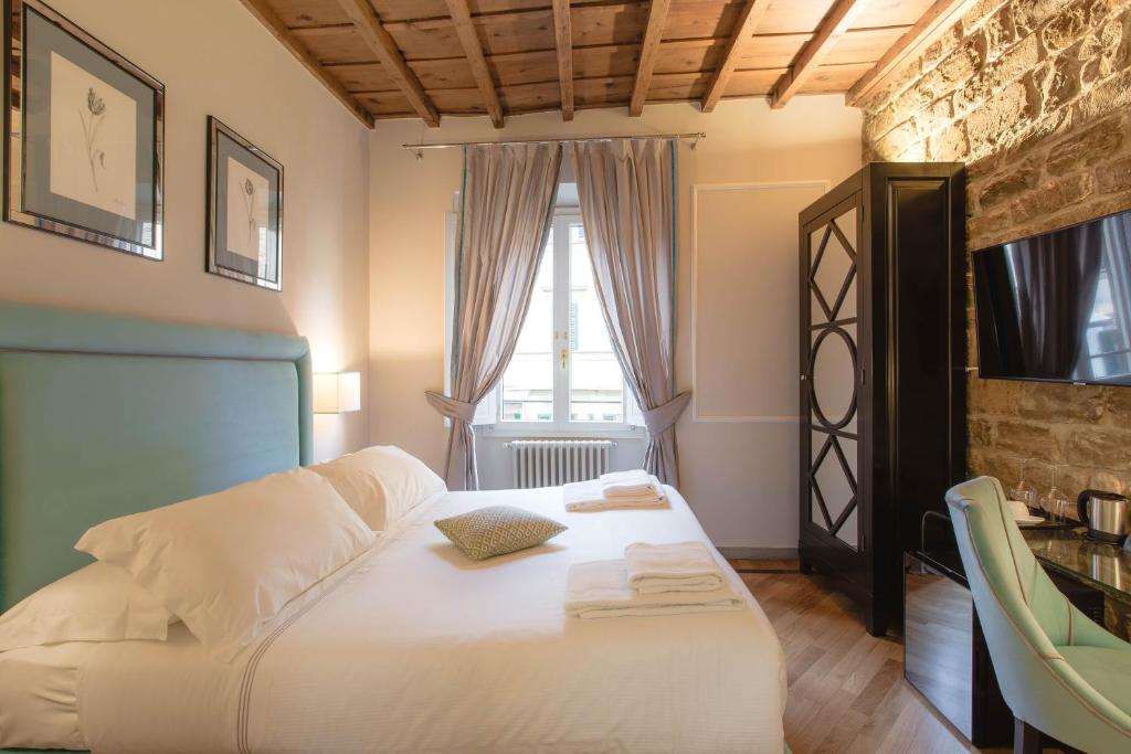 Postel nebo postele na pokoji v ubytování Relais Tosinghi