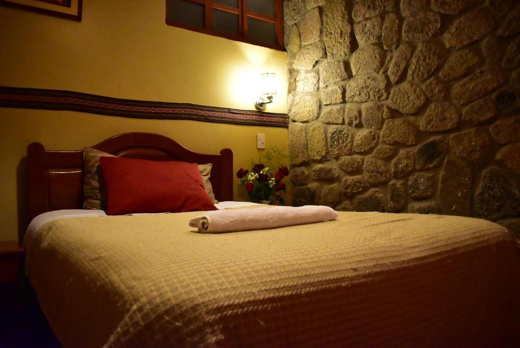 Ένα ή περισσότερα κρεβάτια σε δωμάτιο στο Kuska Hostal