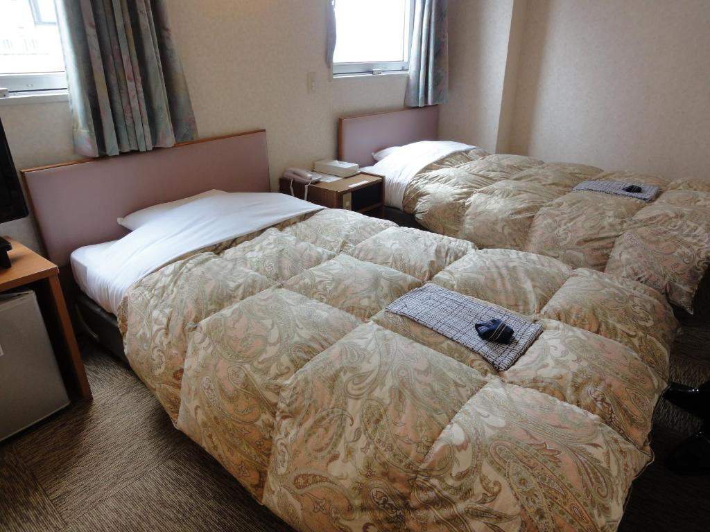 Postel nebo postele na pokoji v ubytování Matsue Plaza Hotel