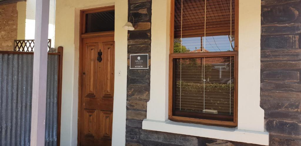 a house with a door and a window at Salty Eyre Glenelg in Glenelg