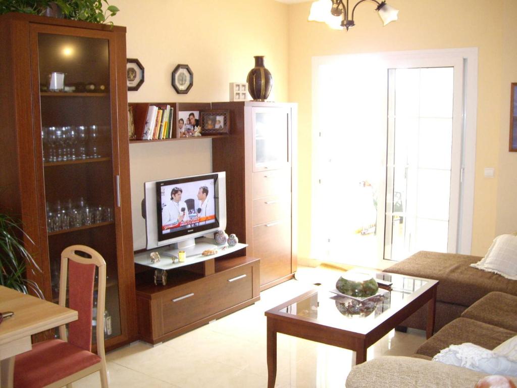 A television and/or entertainment centre at exclusivo Atico en primera línea de playa