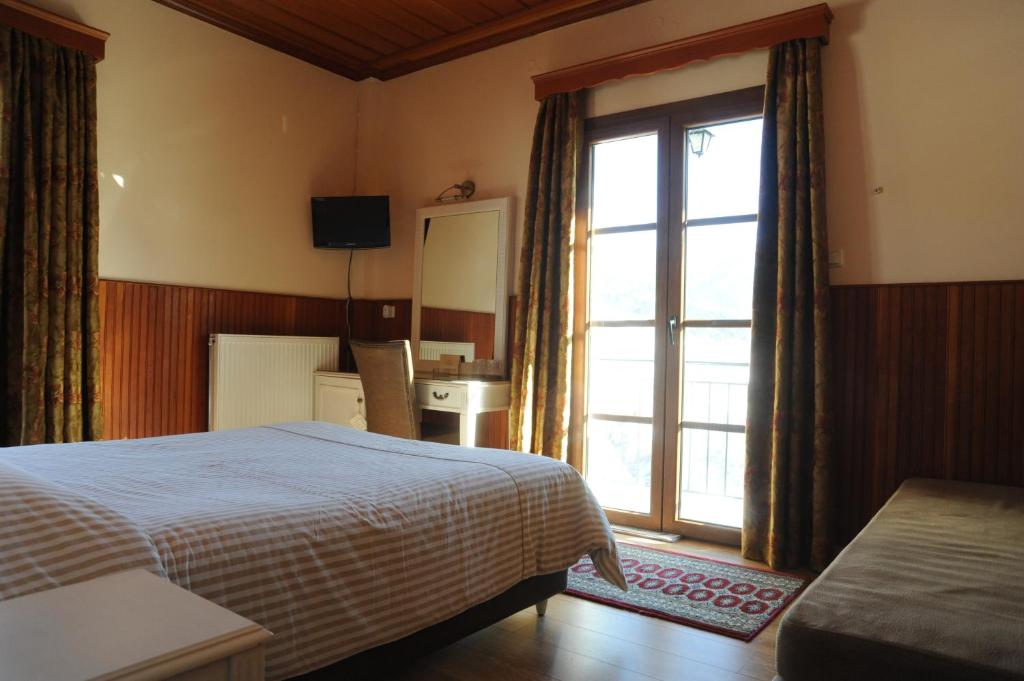 Ένα ή περισσότερα κρεβάτια σε δωμάτιο στο Hotel Olympic