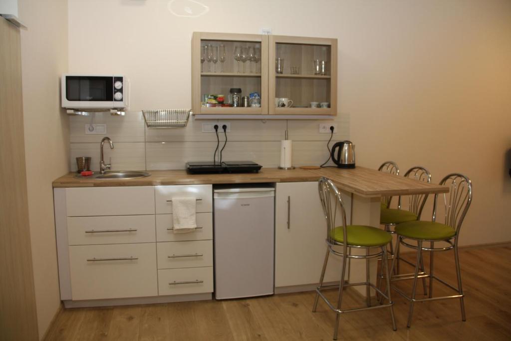 a kitchen with a counter and a table and chairs at Apartament Matejki in Łódź