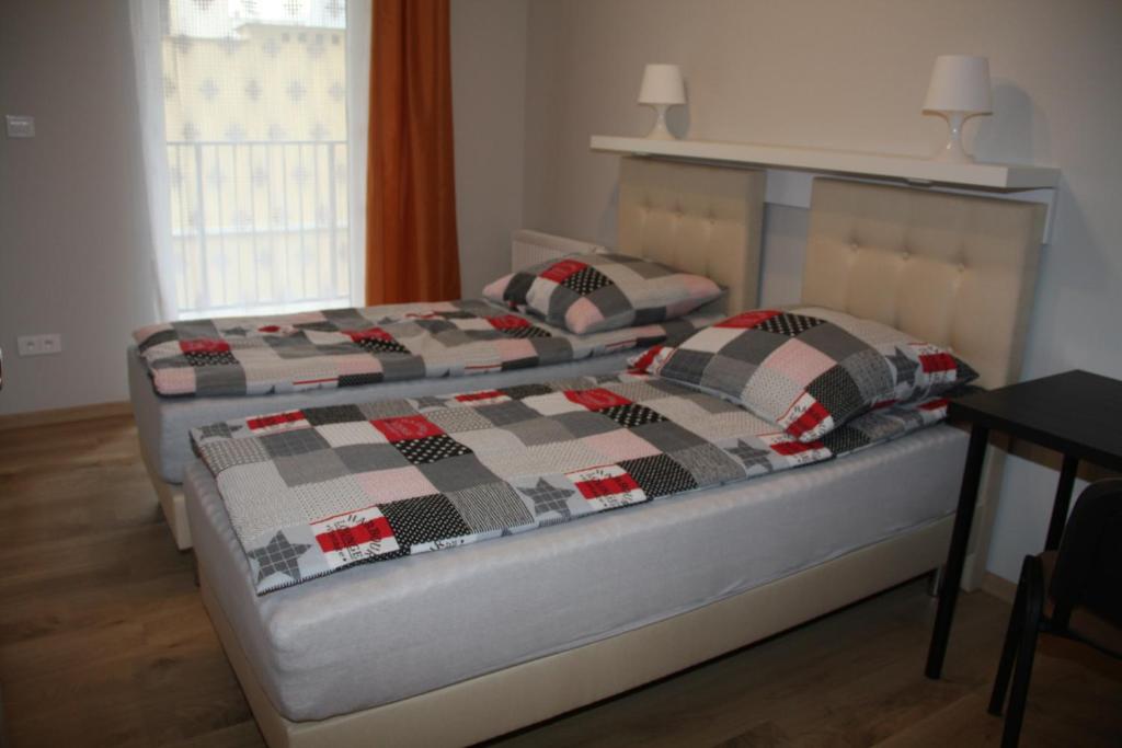 Posteľ alebo postele v izbe v ubytovaní Apartament Matejki