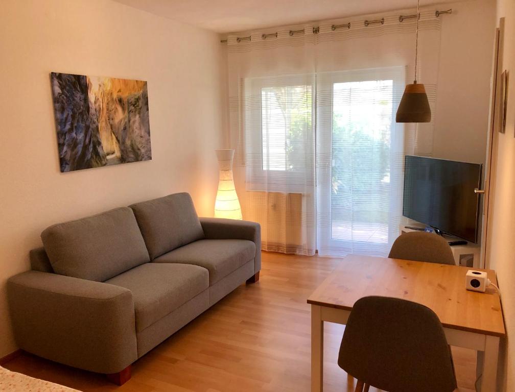 uma sala de estar com um sofá e uma mesa em Bed & Kitchen em Gießen