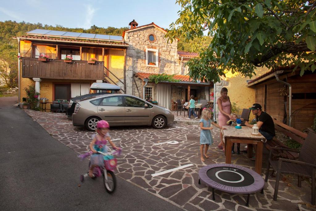 a group of children on a bike in a street at Hostel Xaxid in Črni Kal