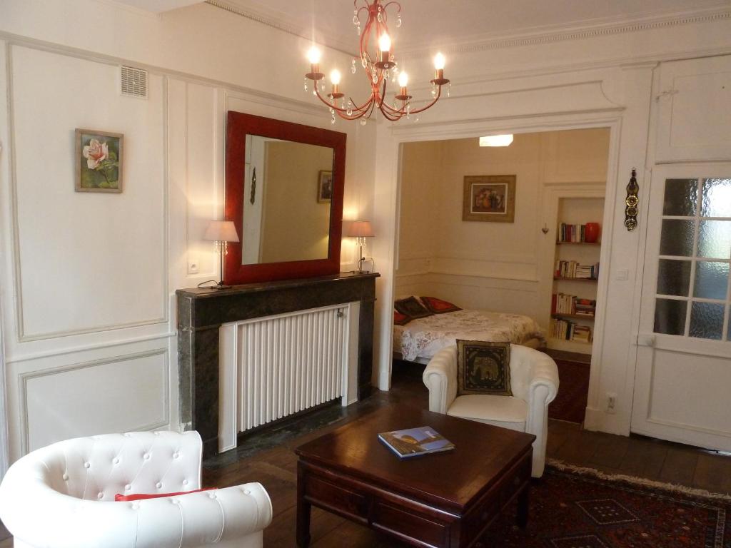 - un salon avec une cheminée et un lit dans l'établissement Le Point d'Orgue, à Rennes