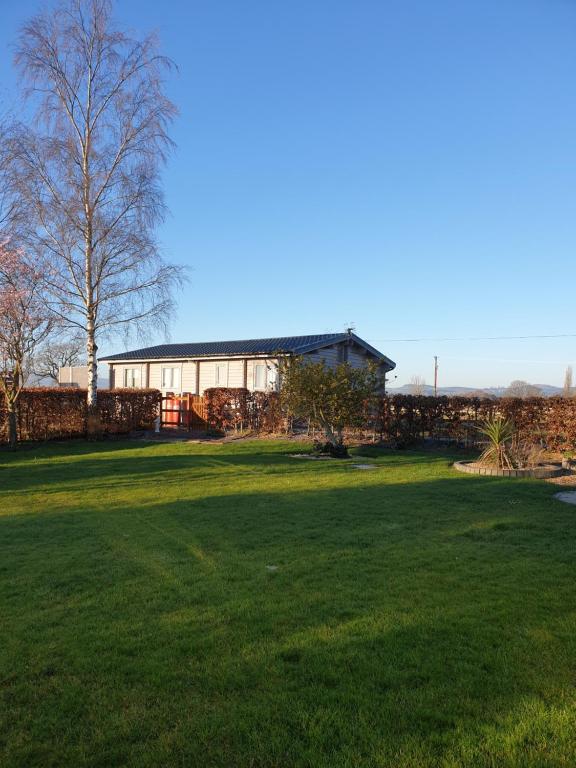 a large yard with a building in the background at Ruth's Retreat in Shrewsbury