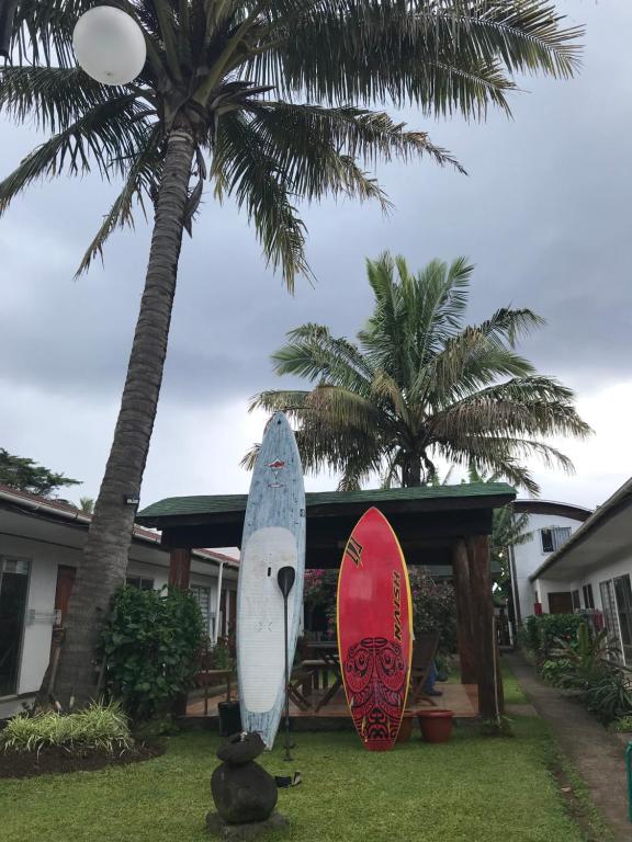 two surfboards on display in front of a house at Inaki Uhi Hotel in Hanga Roa