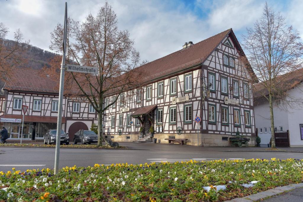 a large wooden building with a street sign in front of it at Hotel Ristorante Rostica in Bad Urach