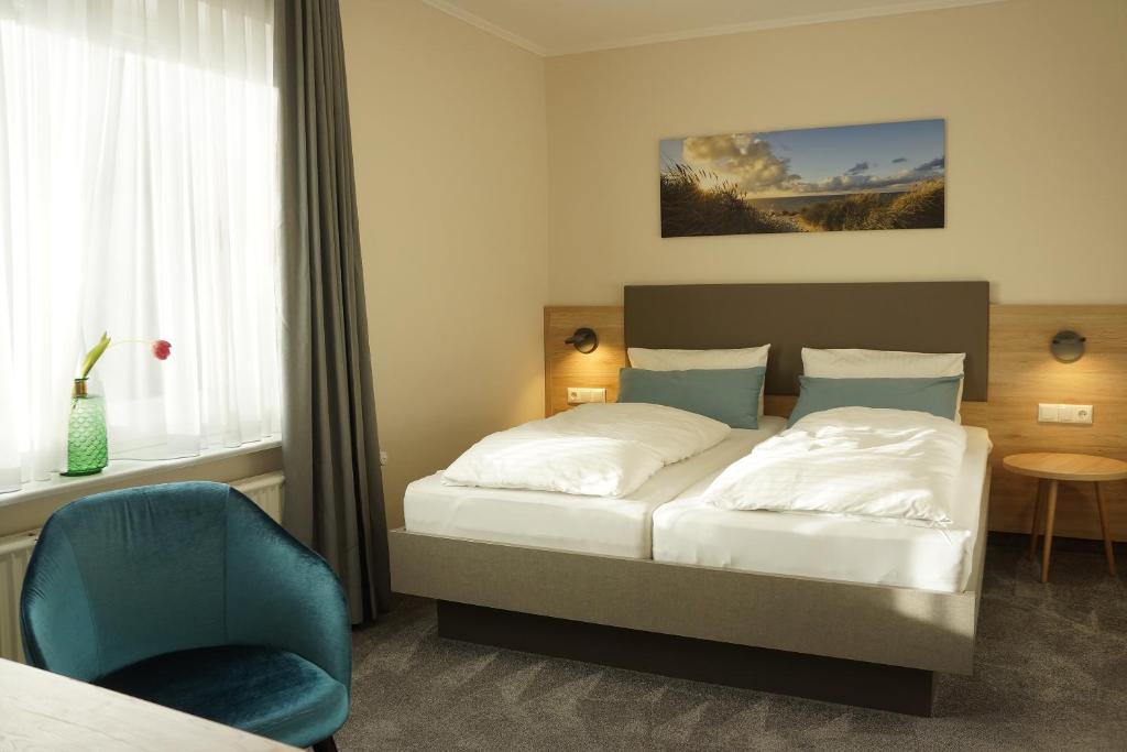 Postel nebo postele na pokoji v ubytování Hotel am Südwäldchen