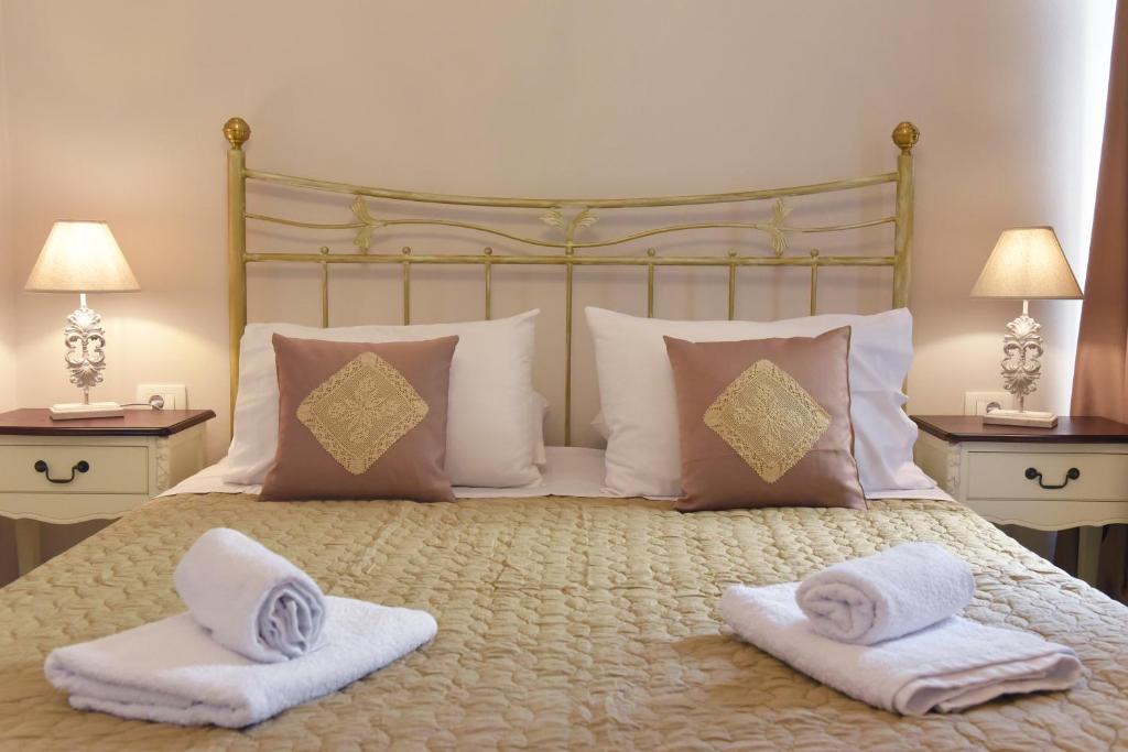 a bed with towels and pillows on top of it at Oisyra Hotel in Ermoupoli