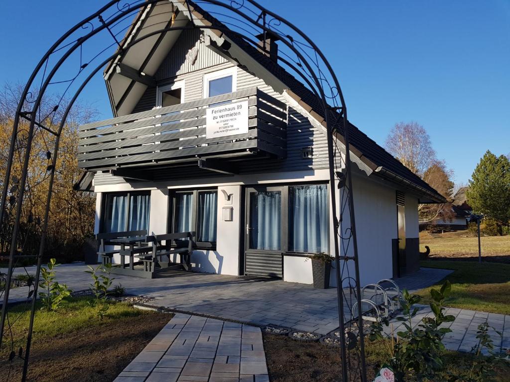 a house with an arbor in front of it at Ferienhaus 89 am Silbersee in Frielendorf
