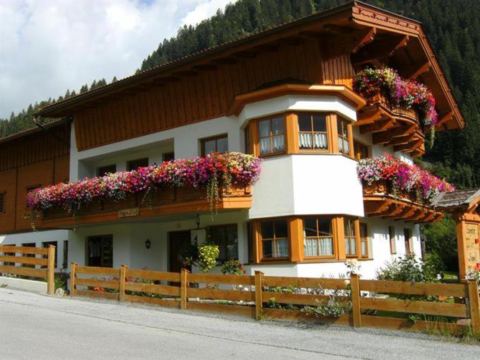 a house with flower boxes on the front of it at Sägehof in Neustift im Stubaital