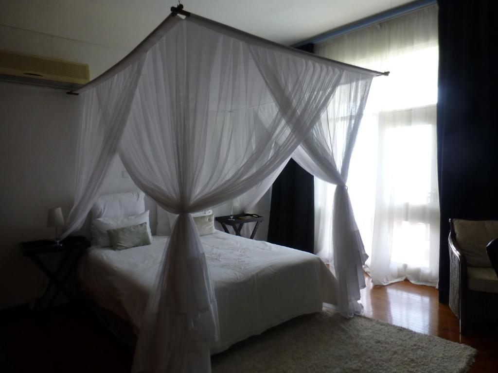 Postel nebo postele na pokoji v ubytování FIGTREE GUESTHOUSE