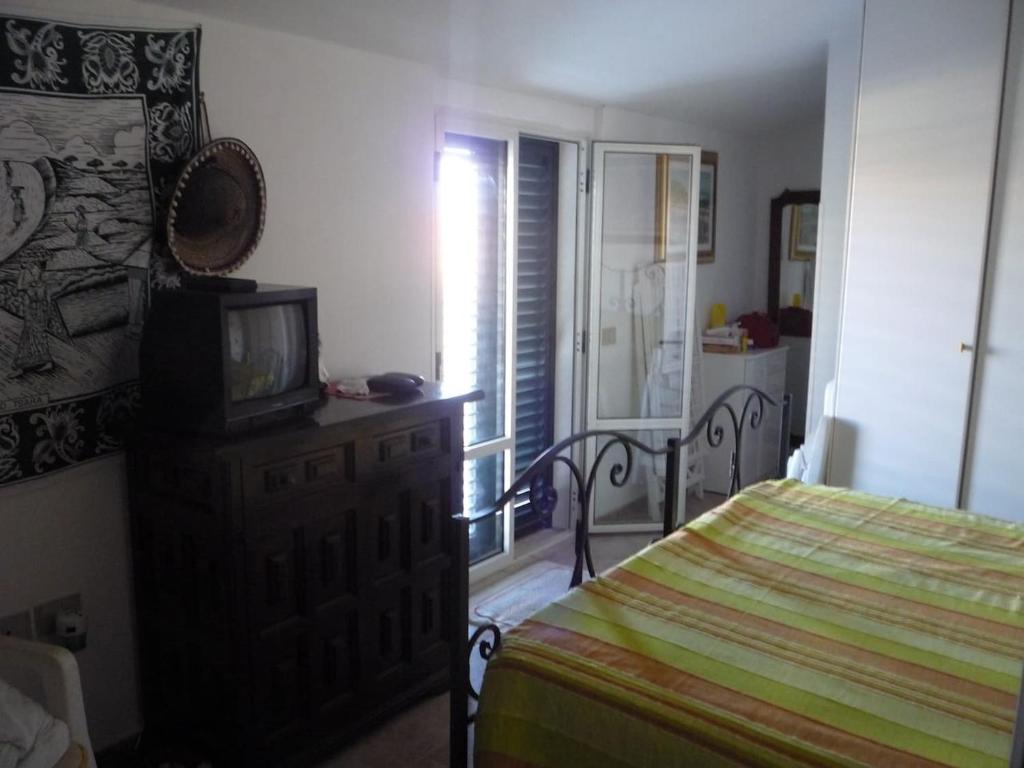 A bed or beds in a room at Graziosa Casa A 2 passi dalla Spiaggia e dal Castello