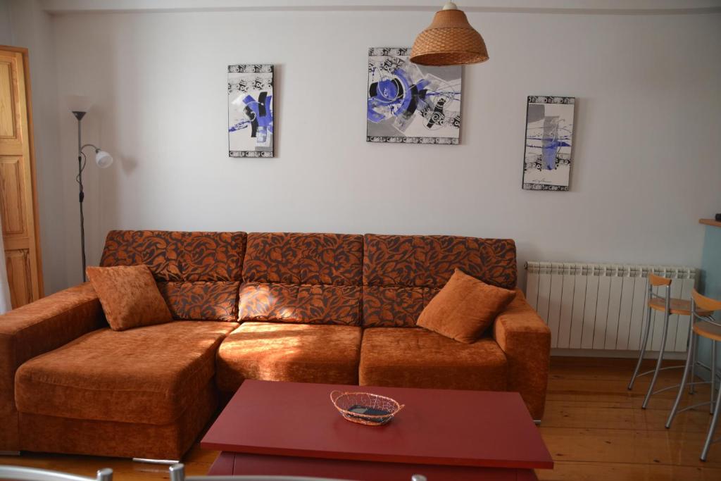 a living room with a brown couch and a table at Romy in Lumbier