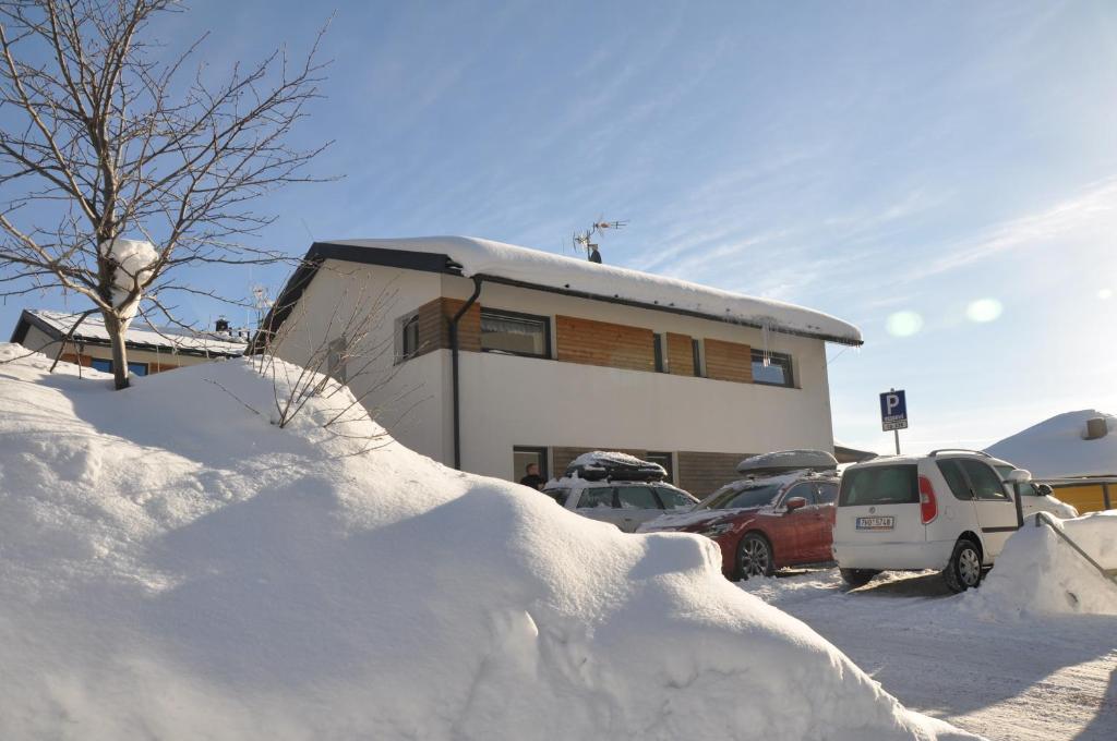 a pile of snow in front of a building at Apartmany Jana in Janske Lazne