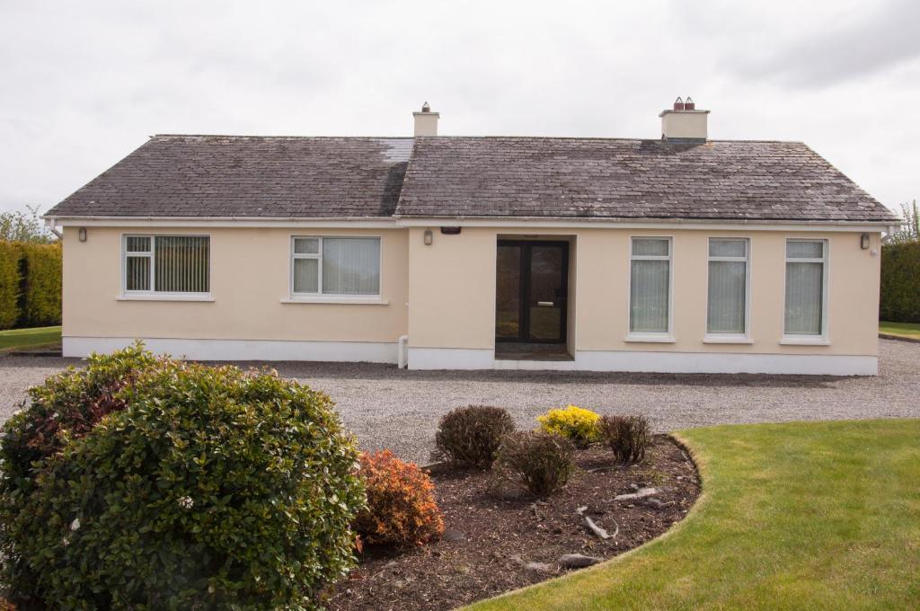 a white house with a driveway at Eagle View Holiday Home in Moone