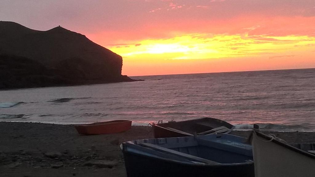 two boats sitting on the beach at sunset at LA ORILLA BEACH HOUSE in Lajita