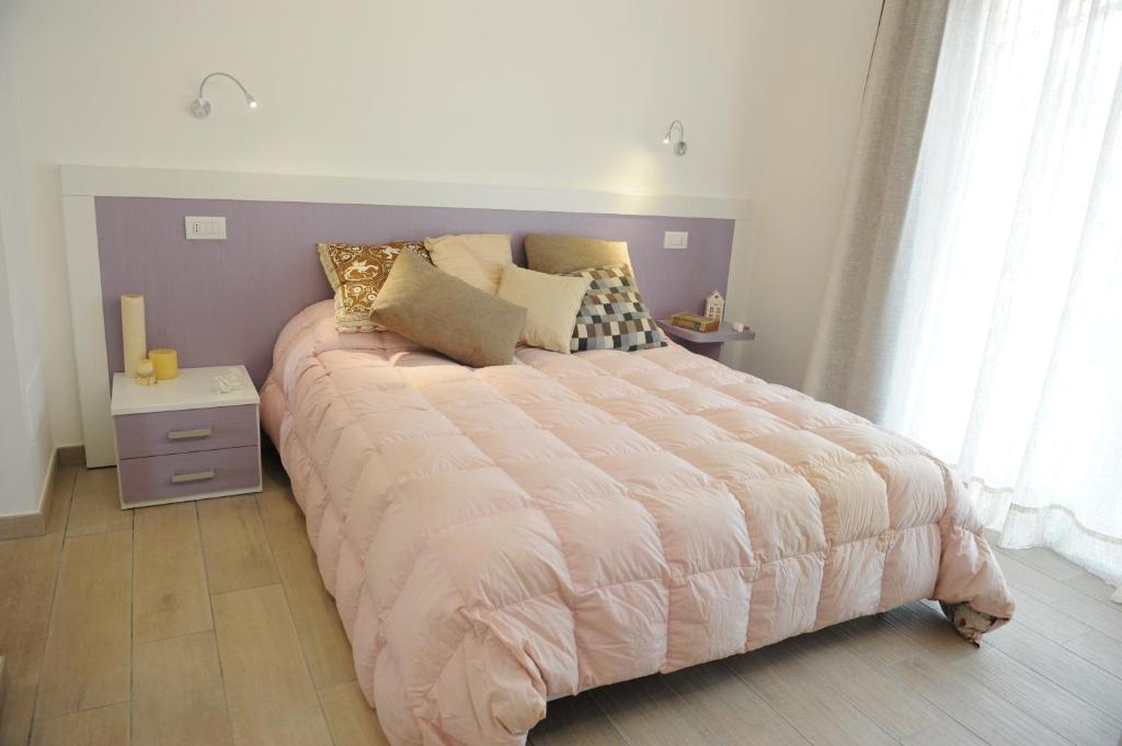 A bed or beds in a room at Il Granaio di Rossetti Elisabetta