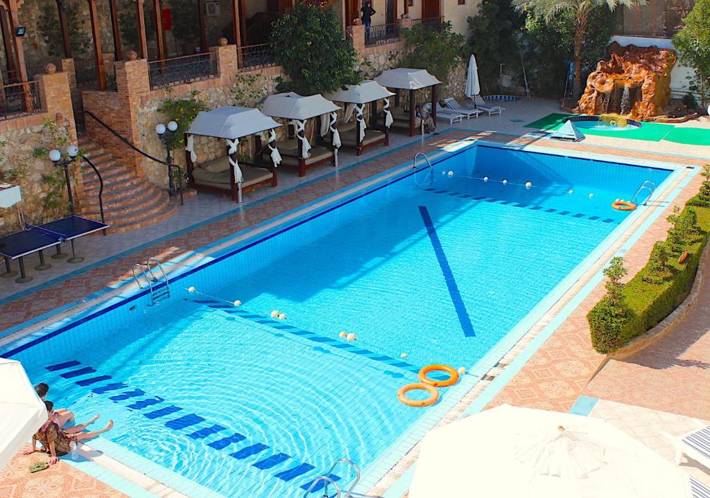 an overhead view of a swimming pool with chairs and umbrellas at Naama Blue Hotel in Sharm El Sheikh