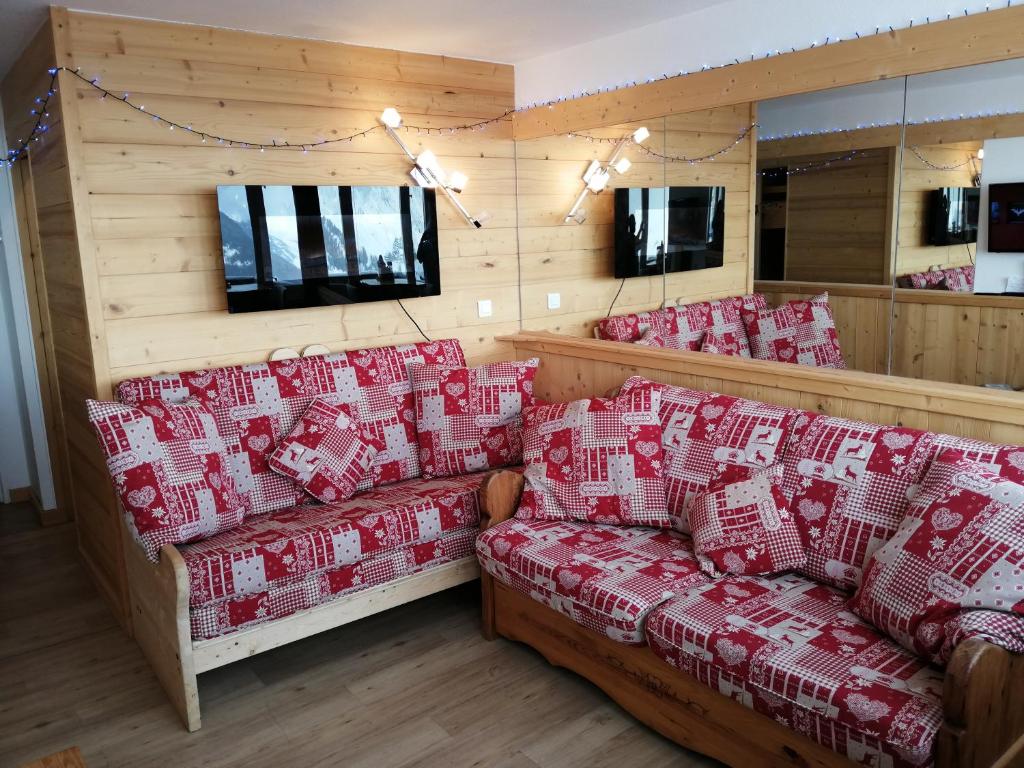 a room with a bunch of couches in a room at Plagne AIME 2000 Ski Apartments in Aime-La Plagne