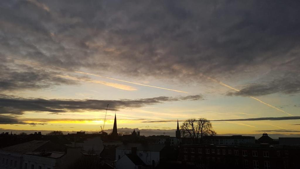 a view of a city at sunset with airplanes at Central Penthouse with Hot Tub & Views 23 in Cheltenham