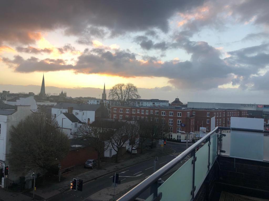 a view of a city with a sunset in the background at Central Penthouse with Hot Tub & Views 23 in Cheltenham