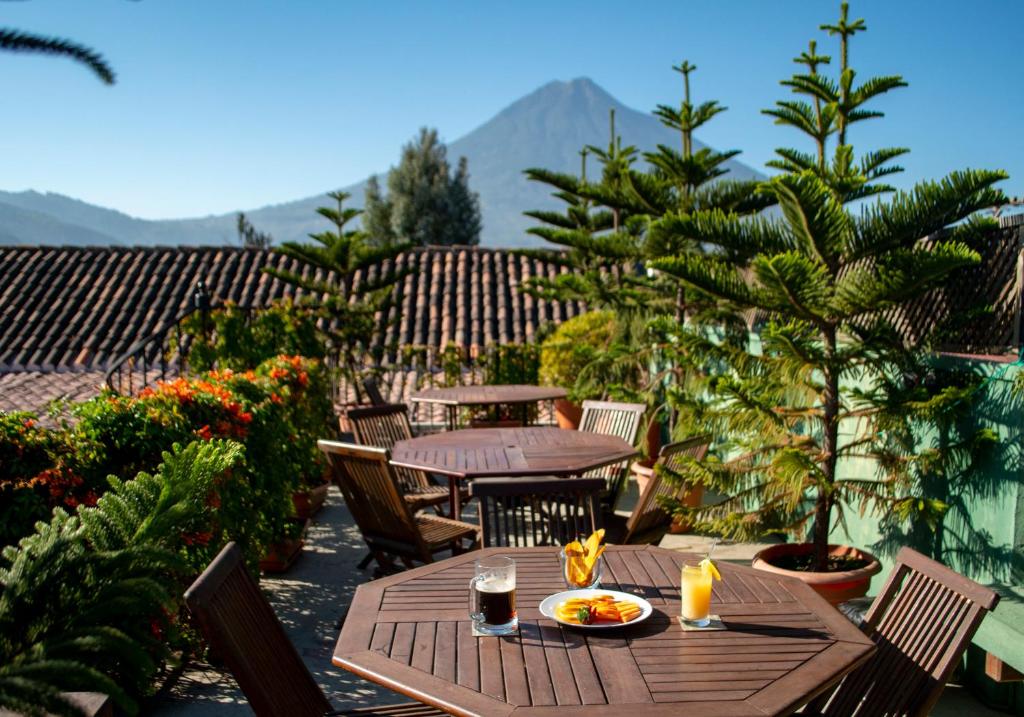 a wooden table and chairs on a patio at Hotel La Catedral in Antigua Guatemala