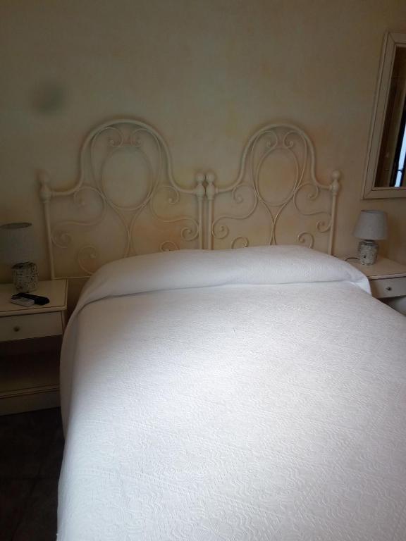 Postel nebo postele na pokoji v ubytování Hotel Sa Cralla Villasimius