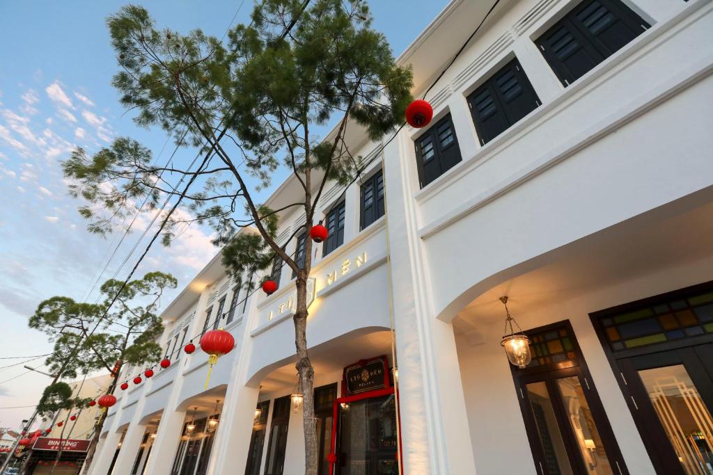 a white building with red balls on it at Liu Men Melaka in Melaka