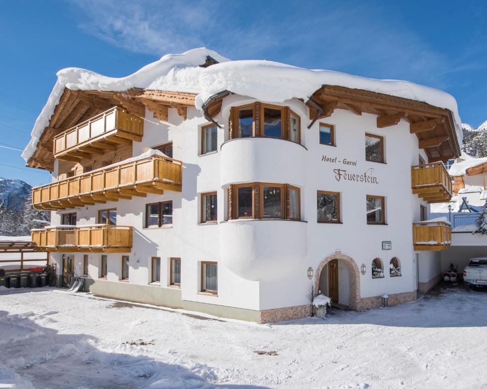 a building with snow on top of it at Hotel Garni Feuerstein in Sankt Anton am Arlberg