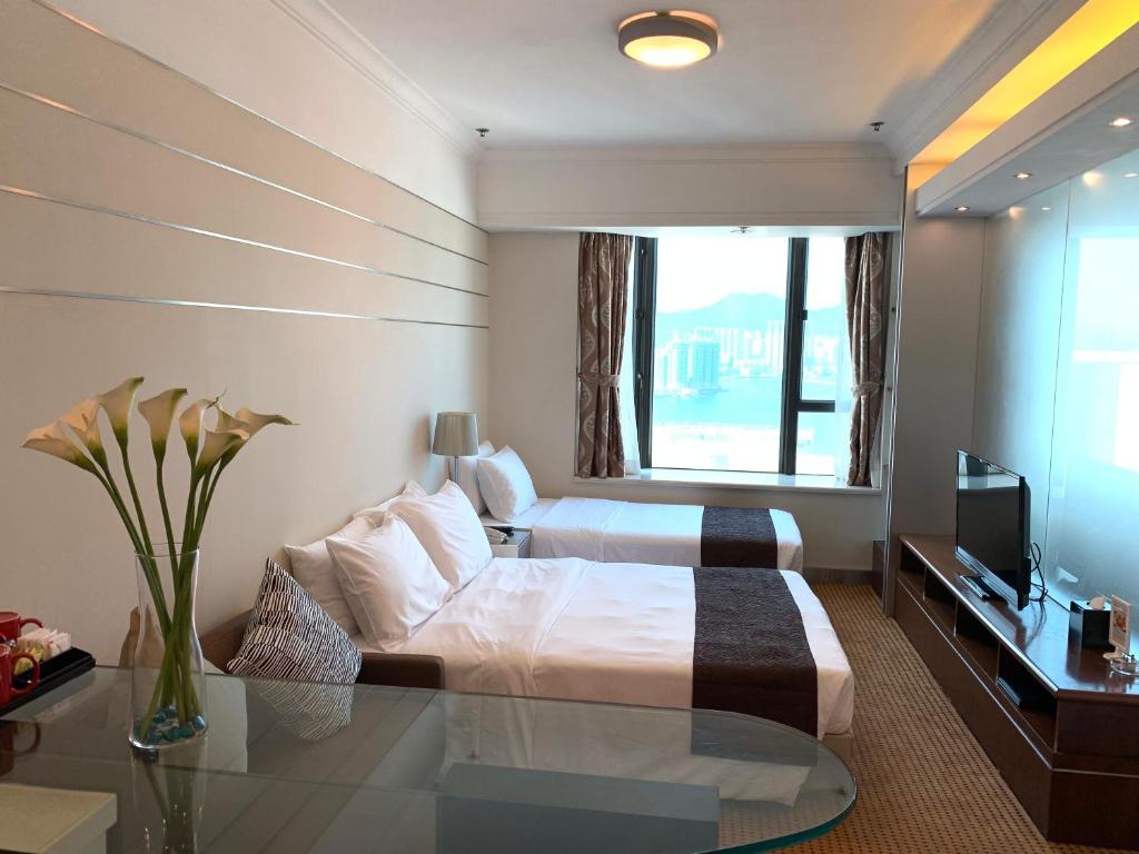 Ένα ή περισσότερα κρεβάτια σε δωμάτιο στο Ramada Hong Kong Grand View