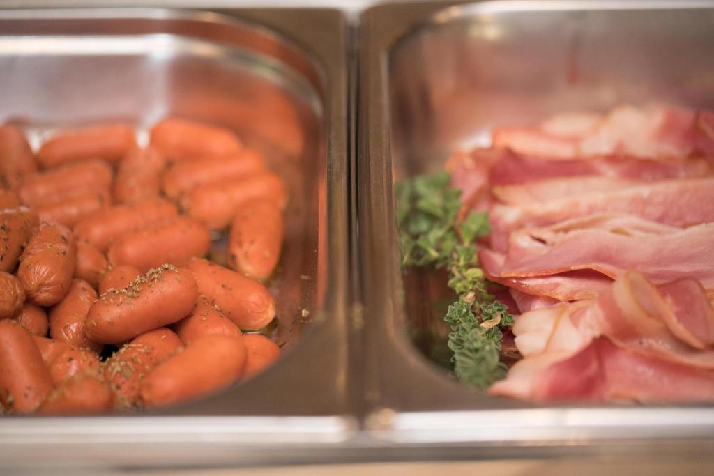 two trays of carrots and other meat and vegetables at Aktaion Resort in Gythio