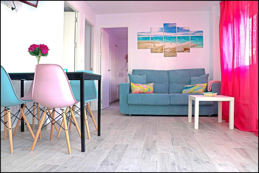 sala de estar con sofá azul y mesa en Apartamento Del Rio Playa en Cádiz