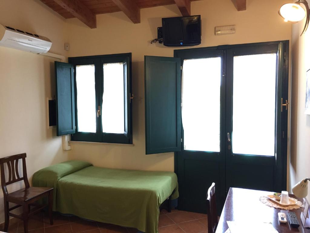 Postel nebo postele na pokoji v ubytování Agriturismo Arangèa