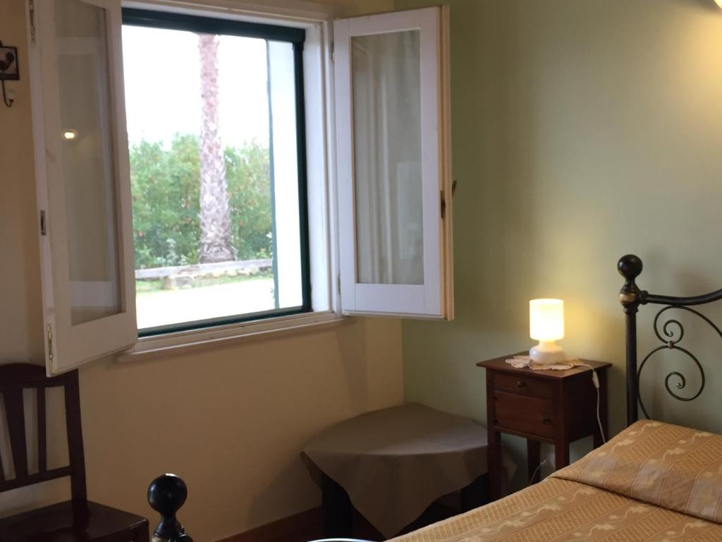 Postel nebo postele na pokoji v ubytování Agriturismo Arangèa