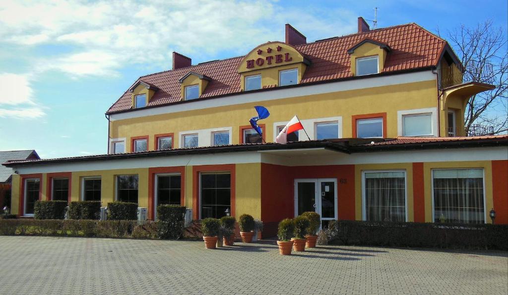 a large white building with a blue roof at Hotel Jester in Wrocław