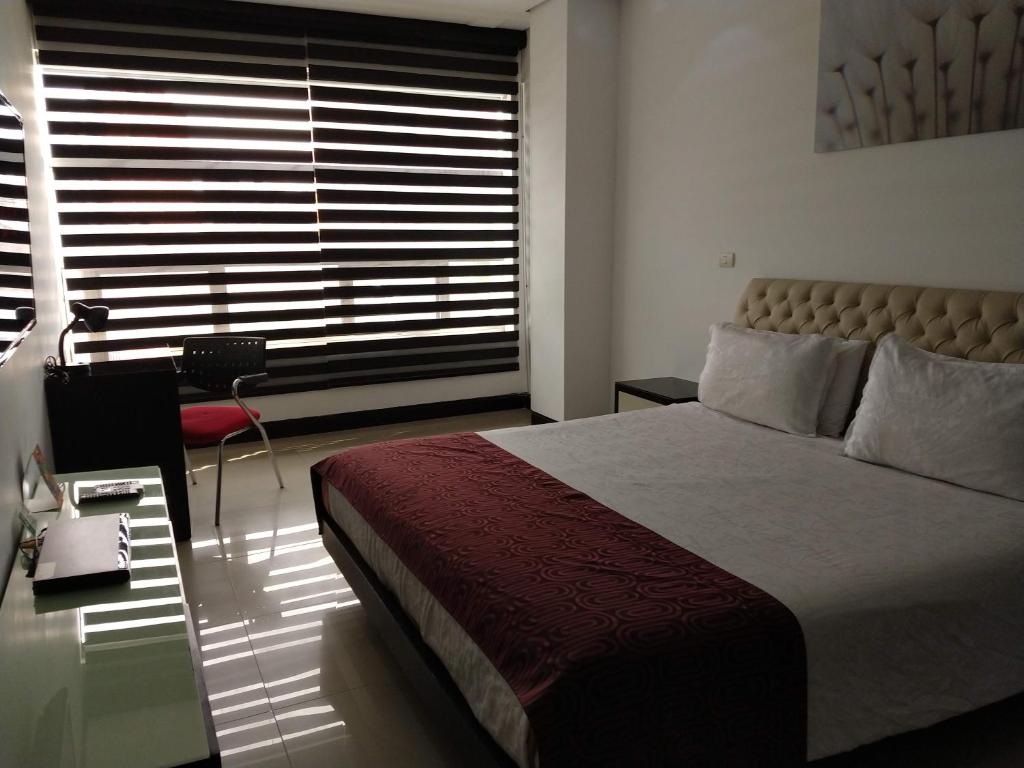 Postel nebo postele na pokoji v ubytování Hotel Merlott 70