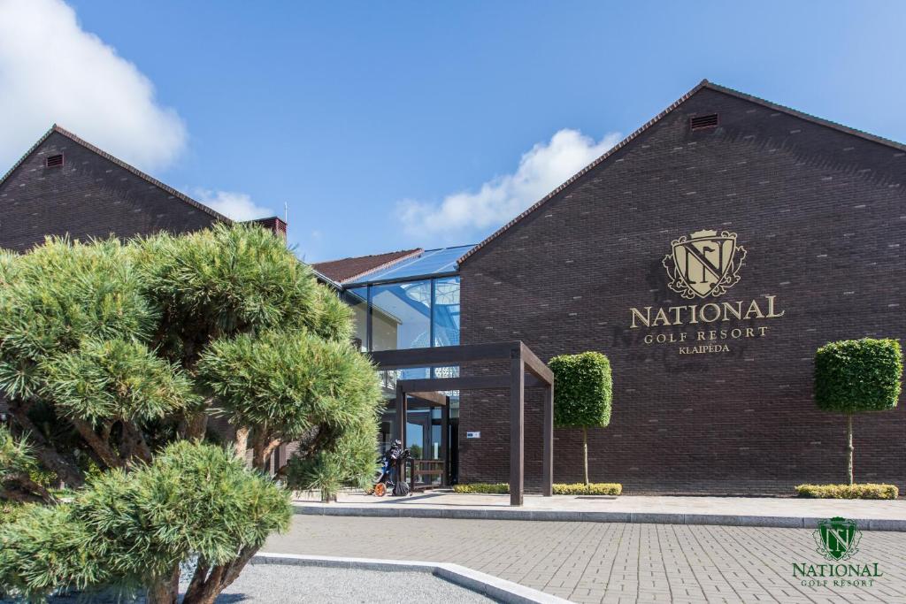 a building with a sign that reads national golf resort at National Golf Resort in Klaipėda