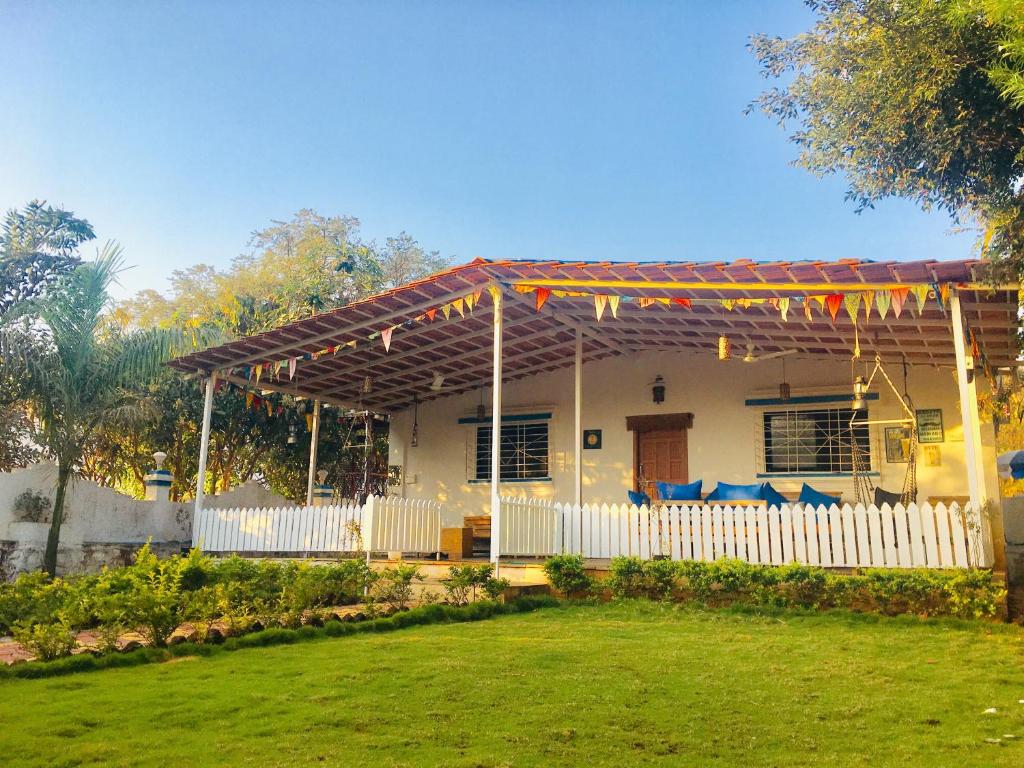 a house with a pergola in a yard at West Valley Farm Villa in Lavasa