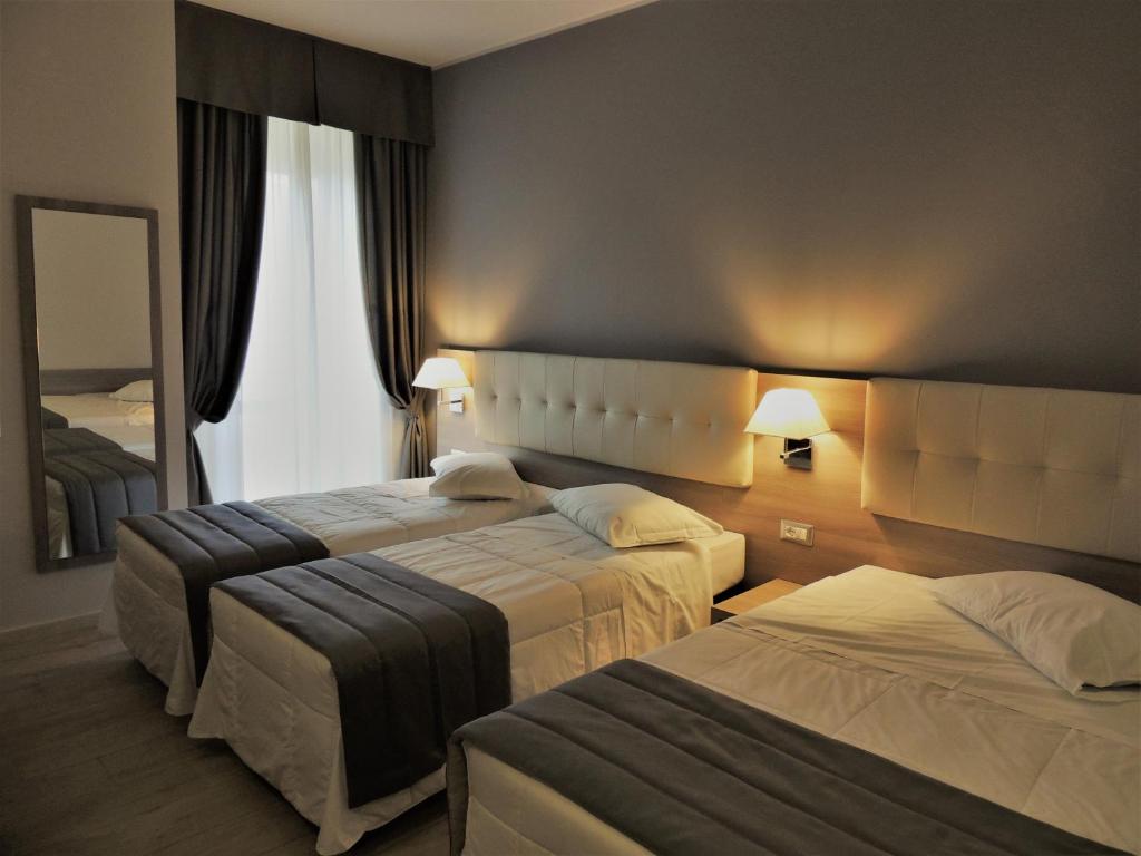 Posteľ alebo postele v izbe v ubytovaní Hotel Accursio