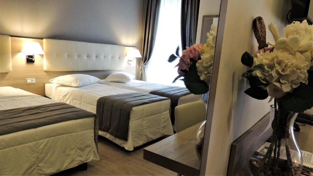 Posteľ alebo postele v izbe v ubytovaní Hotel Accursio